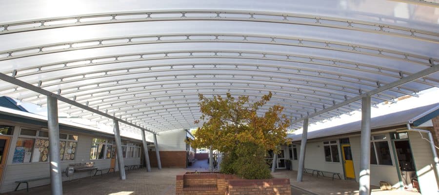 Golden Grove Lutheran Primary School Courtyard Danpalon Roofing SpaceTruss, Clear Curved Roof panels with a Thickness of 16mm by Danpal® Polycarbonate roof offering thermal UV protection.